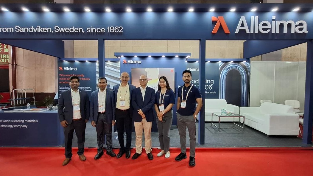 a group of people standing in front of a sign