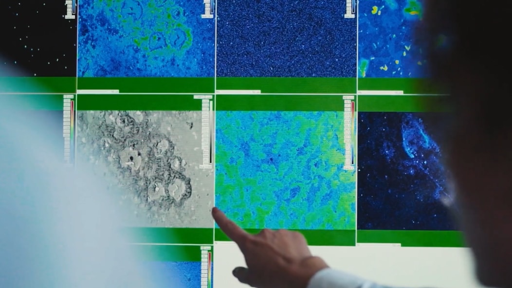 a hand pointing at a screen