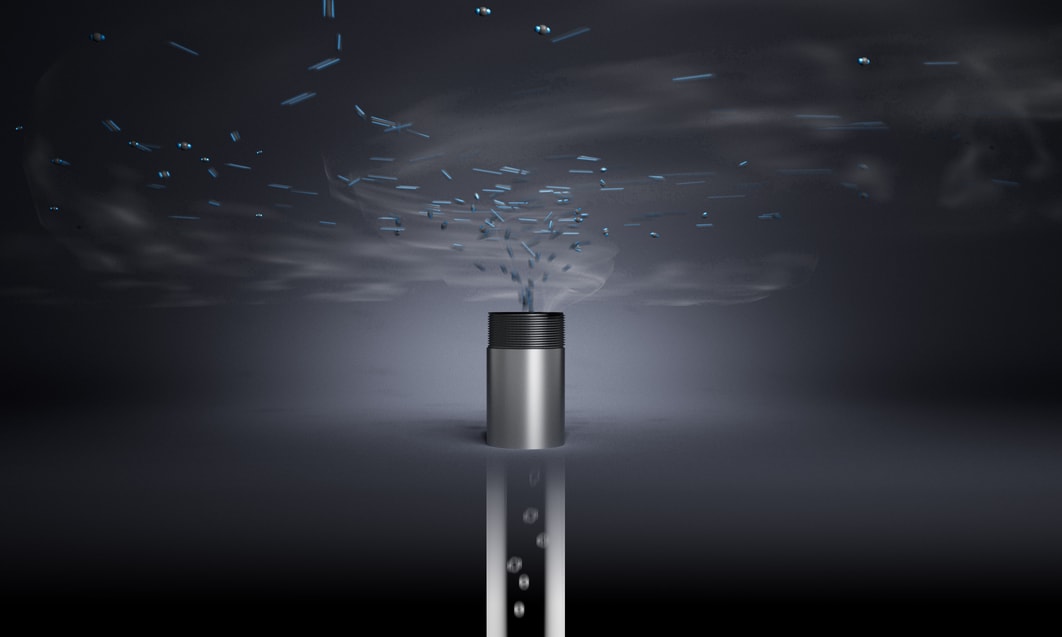 a silver cylinder with smoke coming out of it