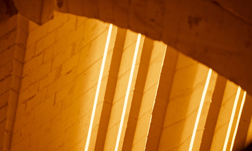 a light shining through a brick wall