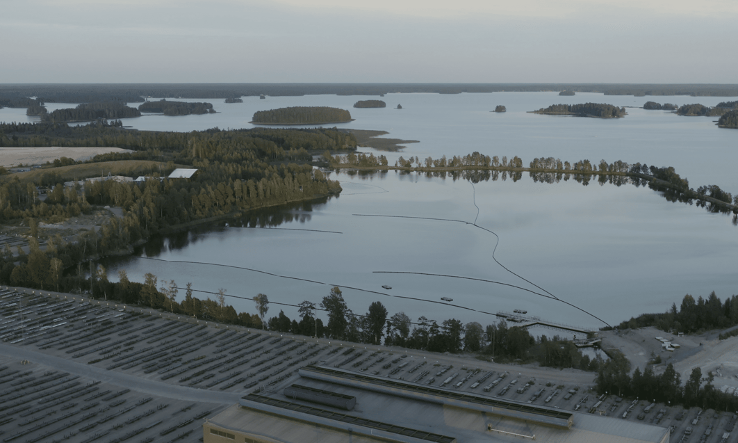 a body of water with trees and buildings