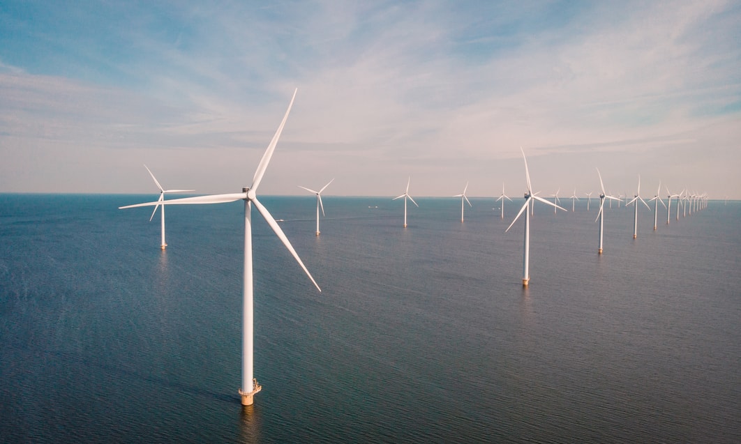 a group of windmills in the water