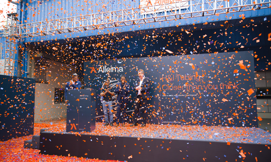 a group of people standing on a stage with confetti falling