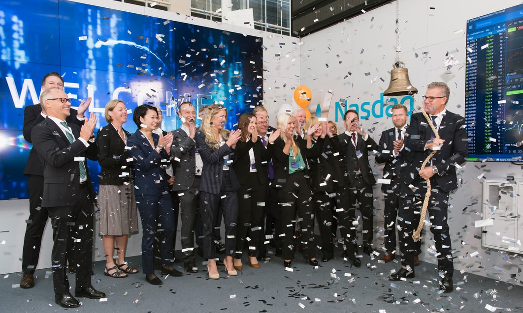 a group of people standing in a line with confetti falling