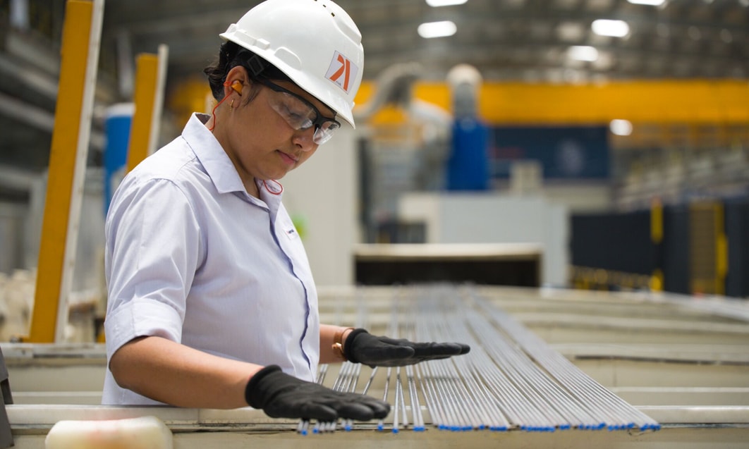 a person wearing a hard hat and gloves