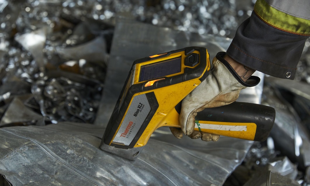 a hand holding a yellow and black device