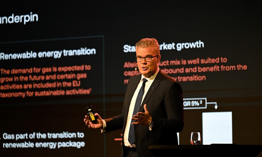 a person in a suit holding a phone