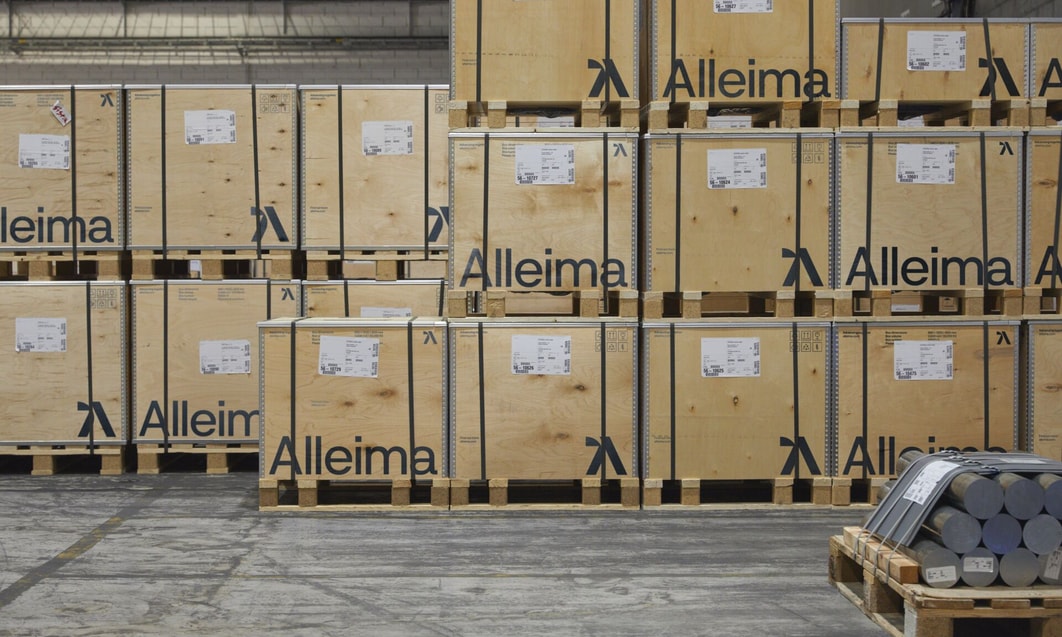 a pallets of wood with a forklift in front of them