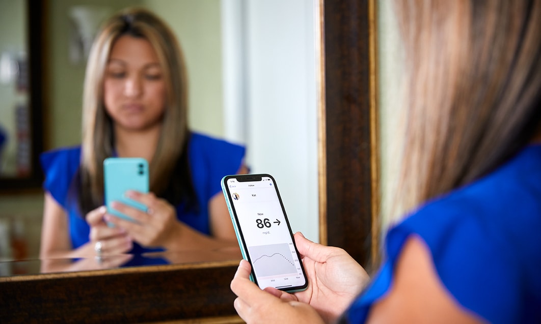 a person holding a phone in front of a mirror