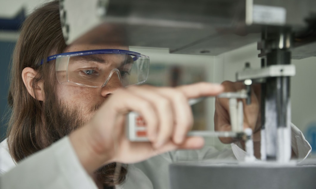 a person wearing goggles and holding a device