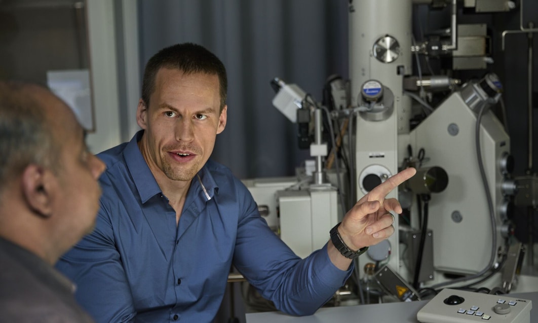 a person pointing at another person