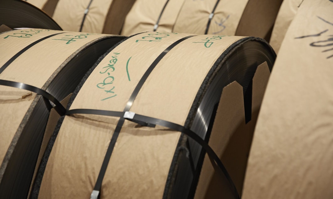 rolls of metal coils with green writing