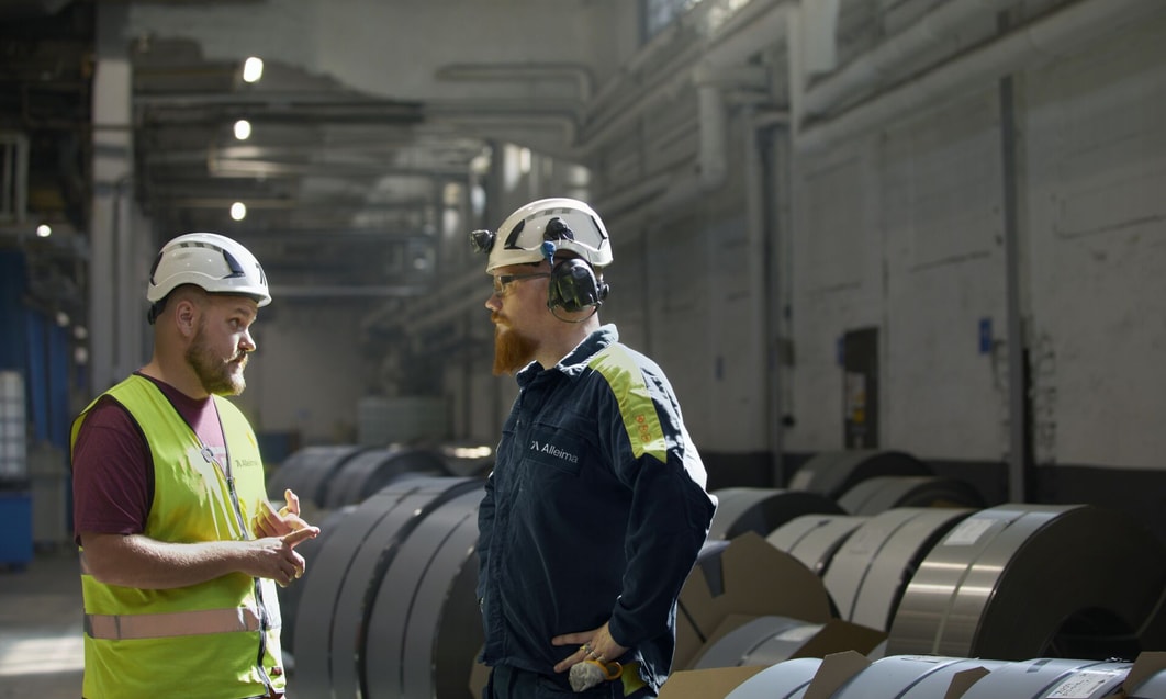 a group of men in hard hats in a factory
