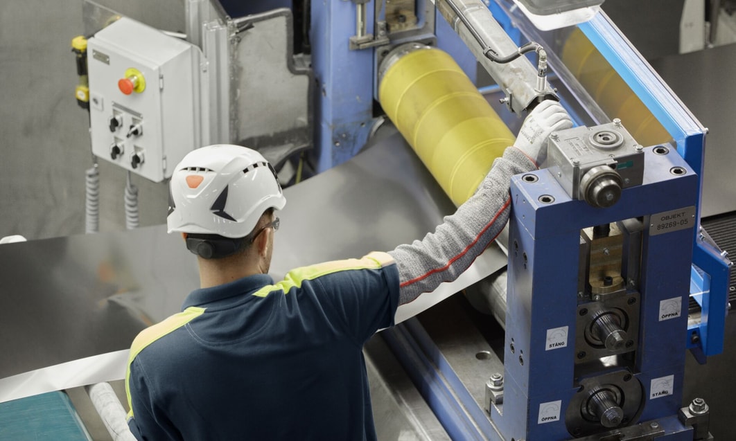 a person in a hard hat working on a machine