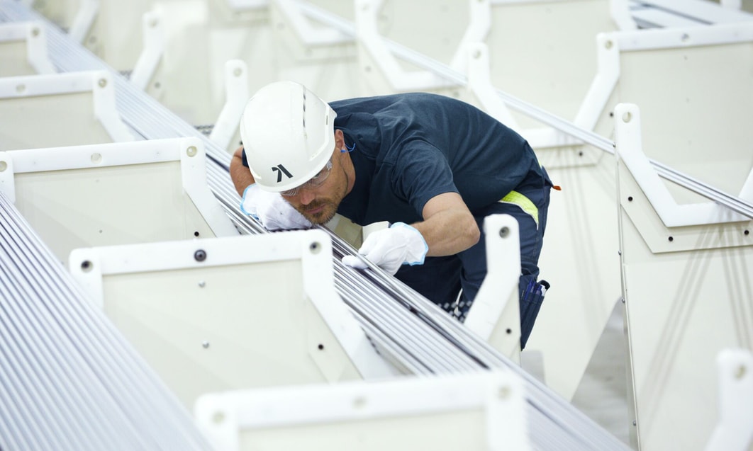 a person wearing a hard hat and gloves