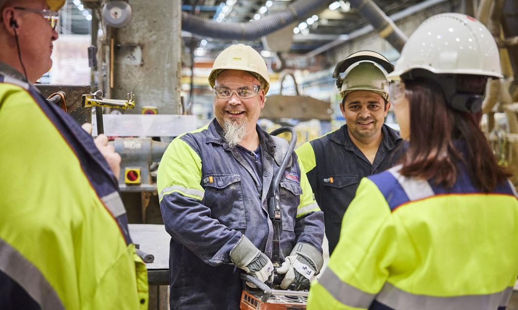 a group of people in hard hats