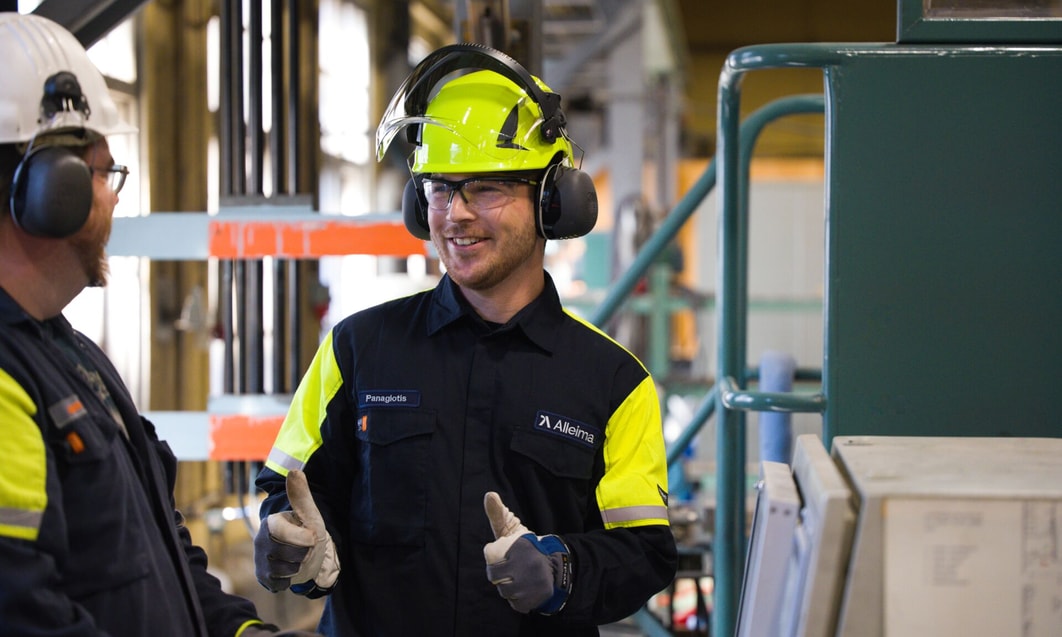 a person wearing a hard hat and gloves