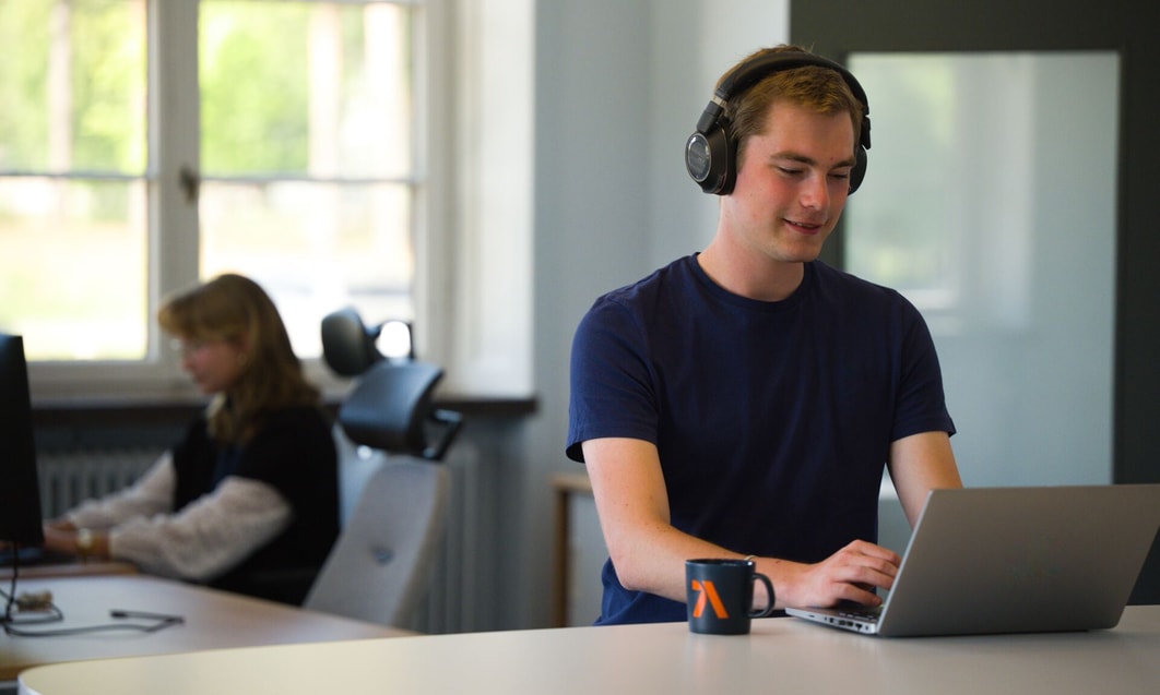 a person wearing headphones and using a laptop