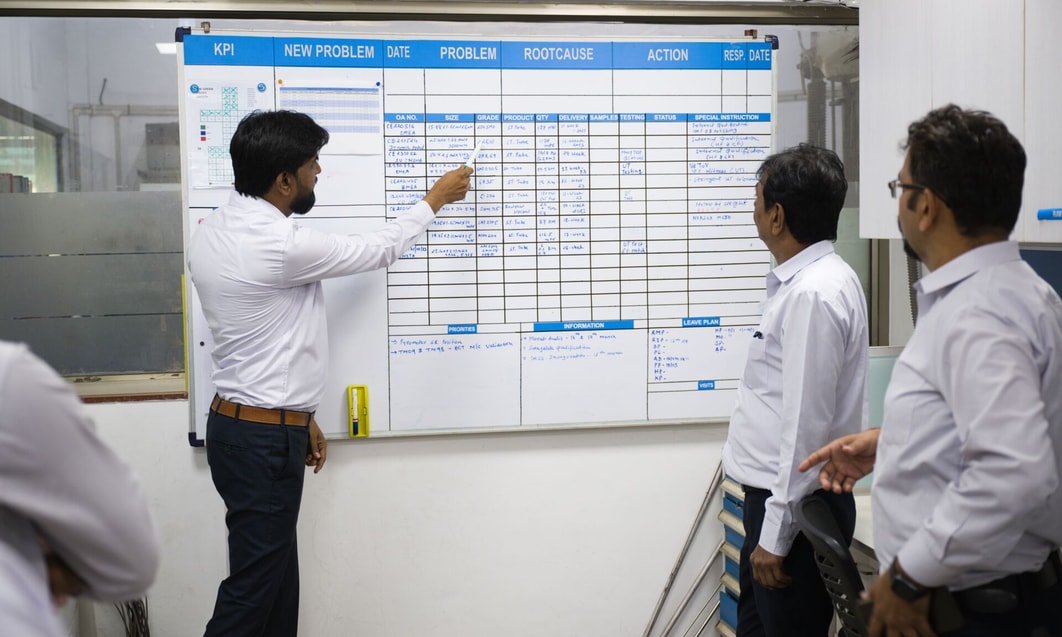 a person pointing at a white board