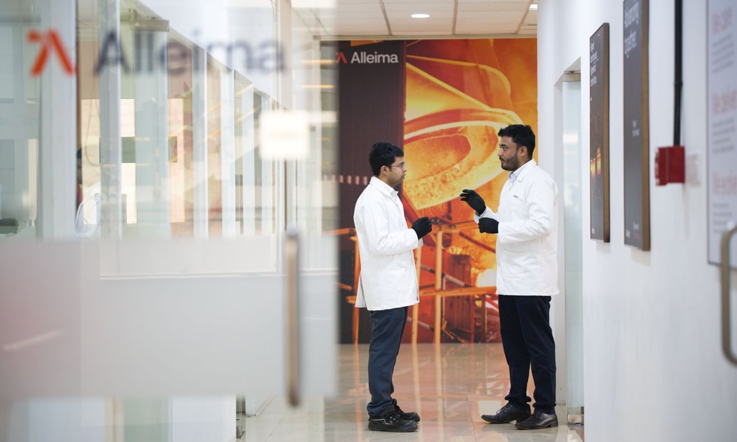 a couple of men in white coats in a hallway