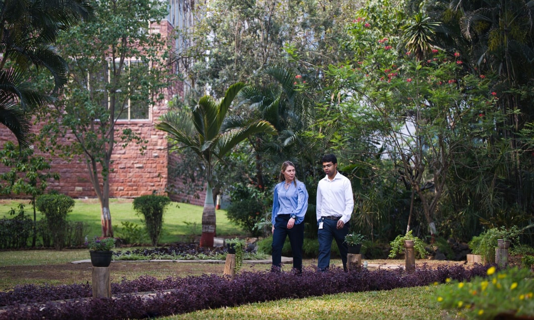 a person and person standing in a garden