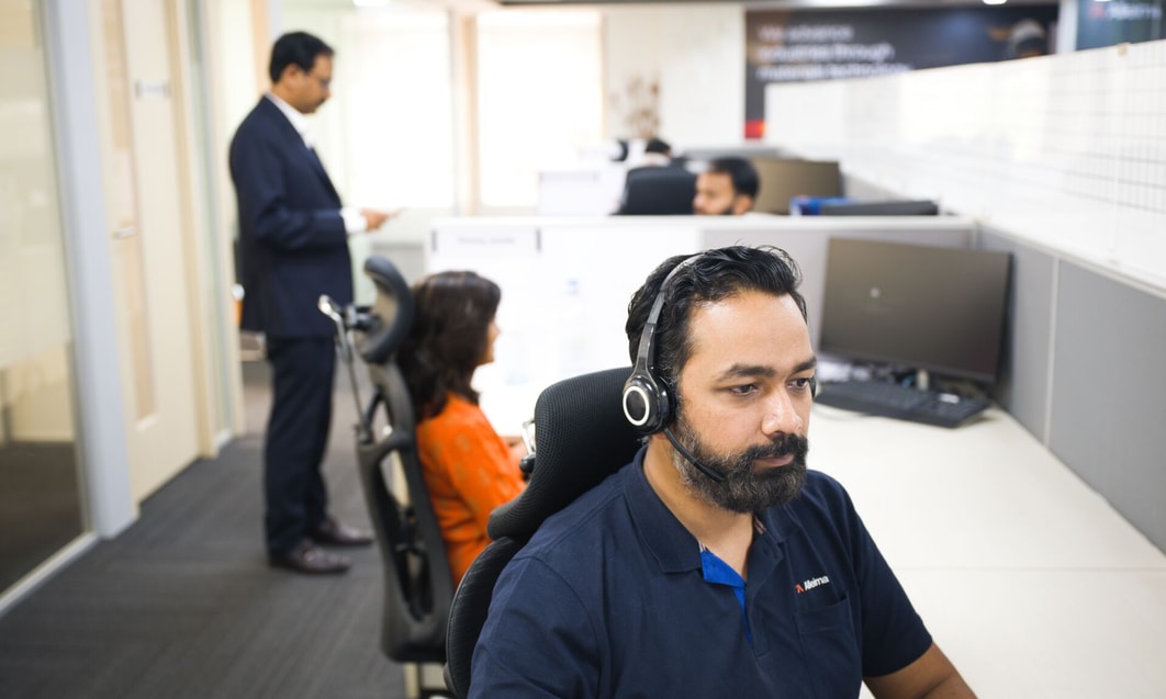 a person wearing a headset and sitting in an office