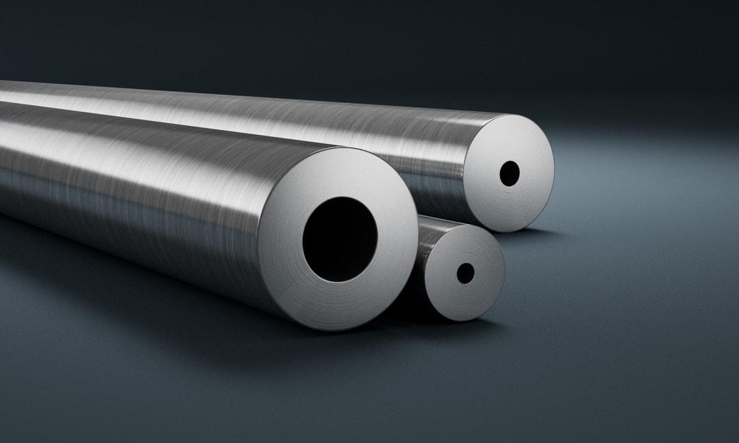 several metal tubes on a grey surface