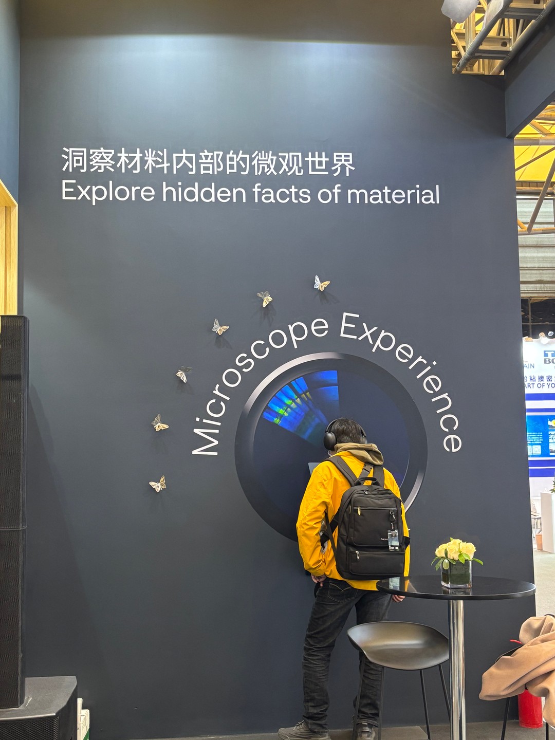 a person standing in front of a wall with butterflies