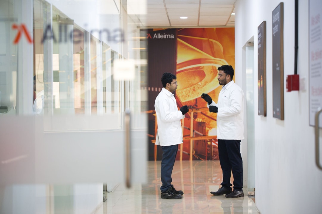 a couple of men in white coats in a hallway