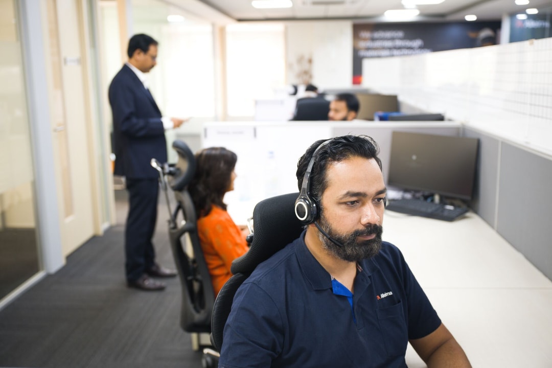 a person wearing a headset and sitting in an office