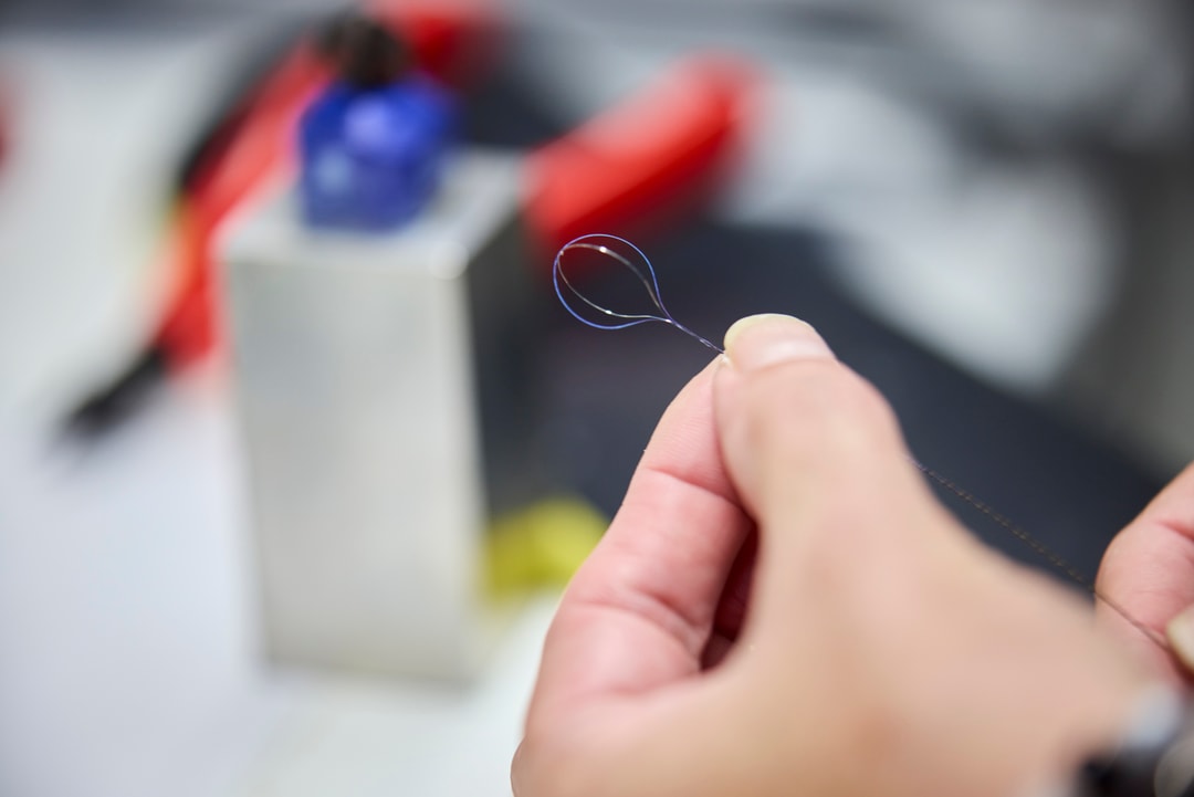 a person holding a thread