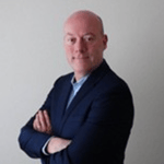 a person in a suit with his arms crossed