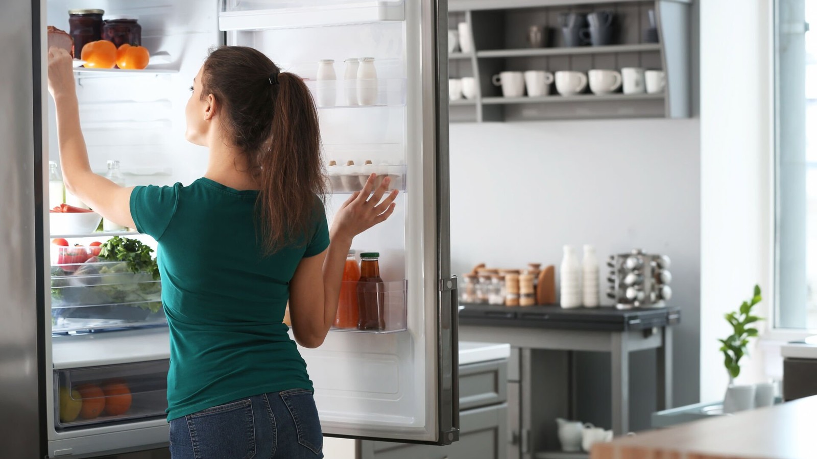 a person looking at a refrigerator