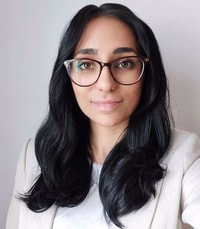 a person with long black hair wearing glasses
