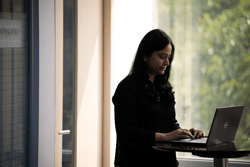 a person standing in front of a laptop