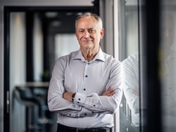 a person standing with his arms crossed