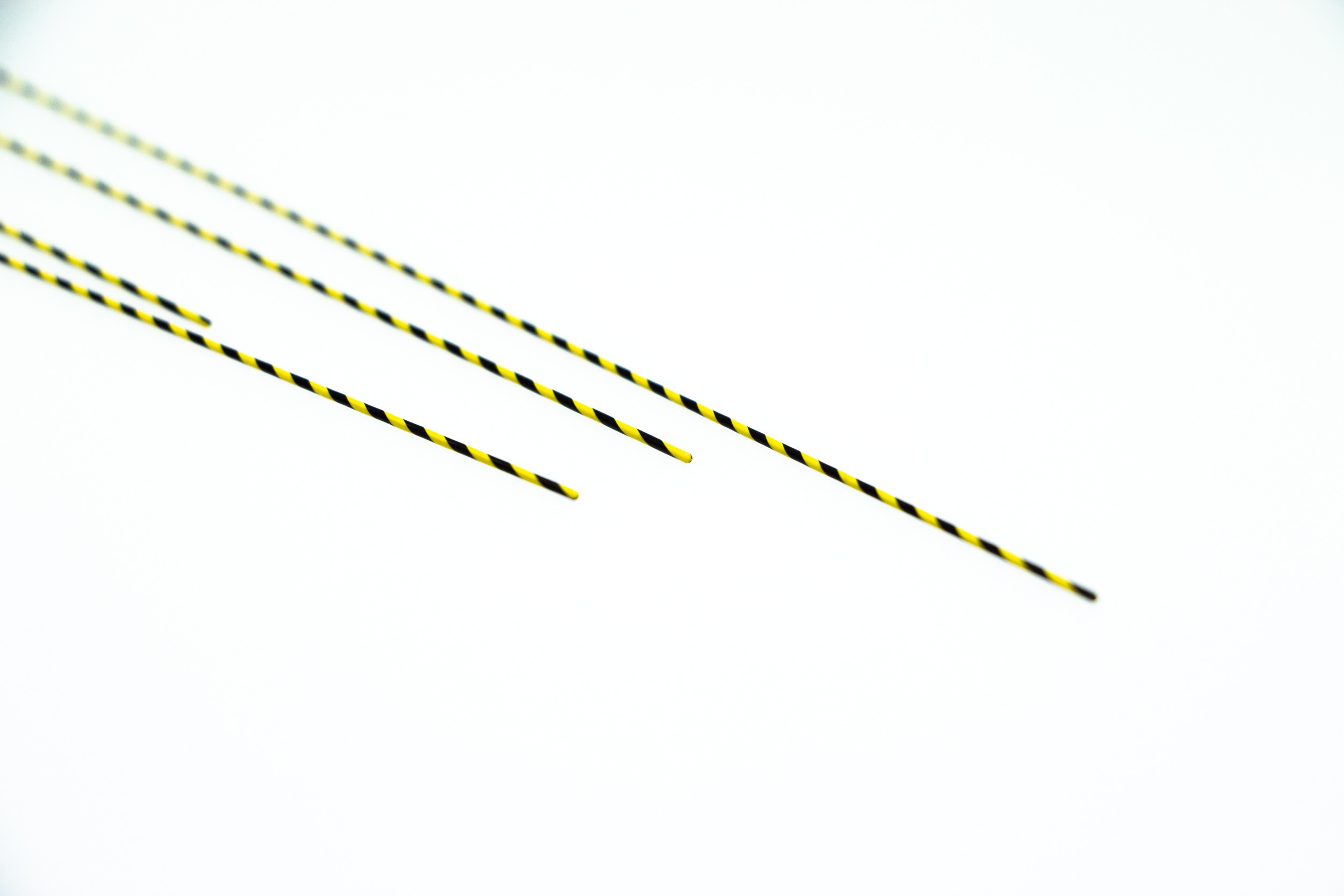 a close-up of a pair of black and yellow striped sticks