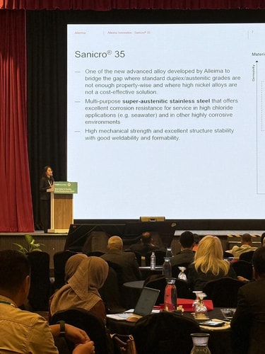 a person standing in front of a screen