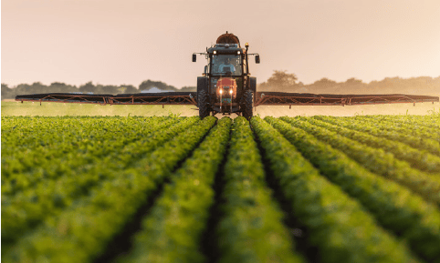 a tractor spraying plants in a field