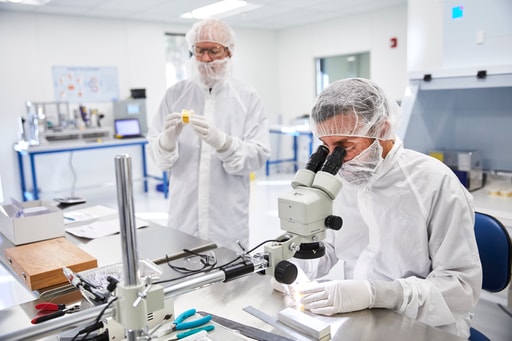 Two Alleima engineers inspecting medical wire