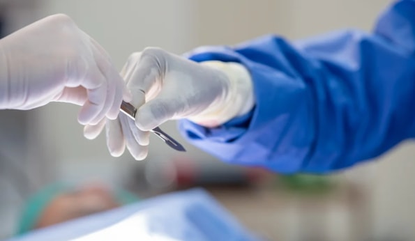 a person holding a scalpel