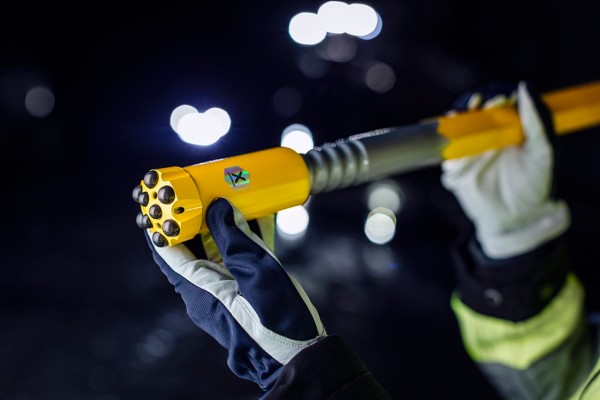a person holding a yellow and grey light