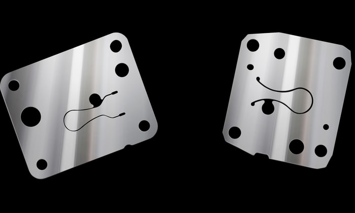 a pair of silver metal objects with a smiley face