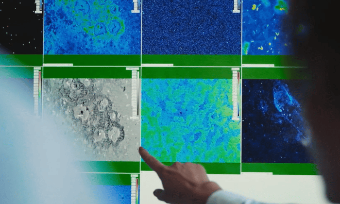 a hand pointing at a screen