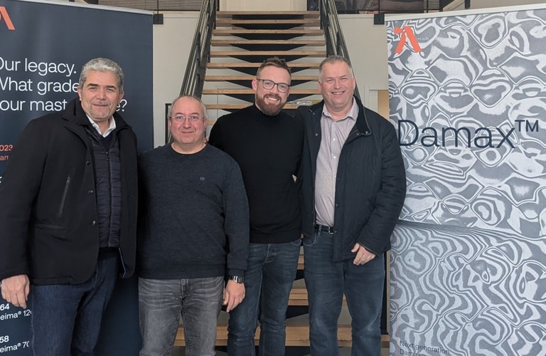 a group of men standing in front of a staircase