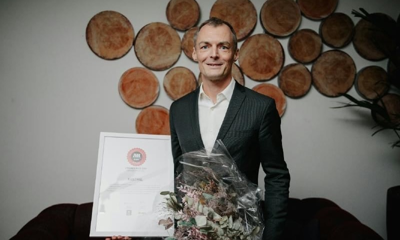 a person holding a bouquet of flowers and a certificate