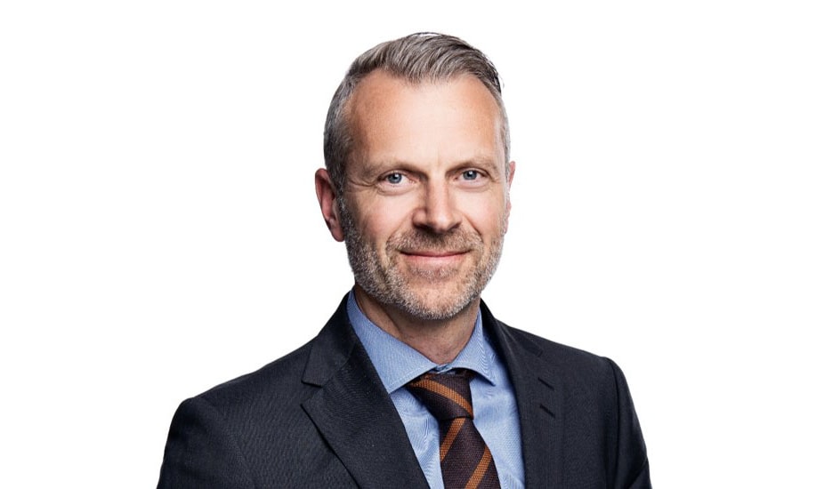 a person in a suit smiling